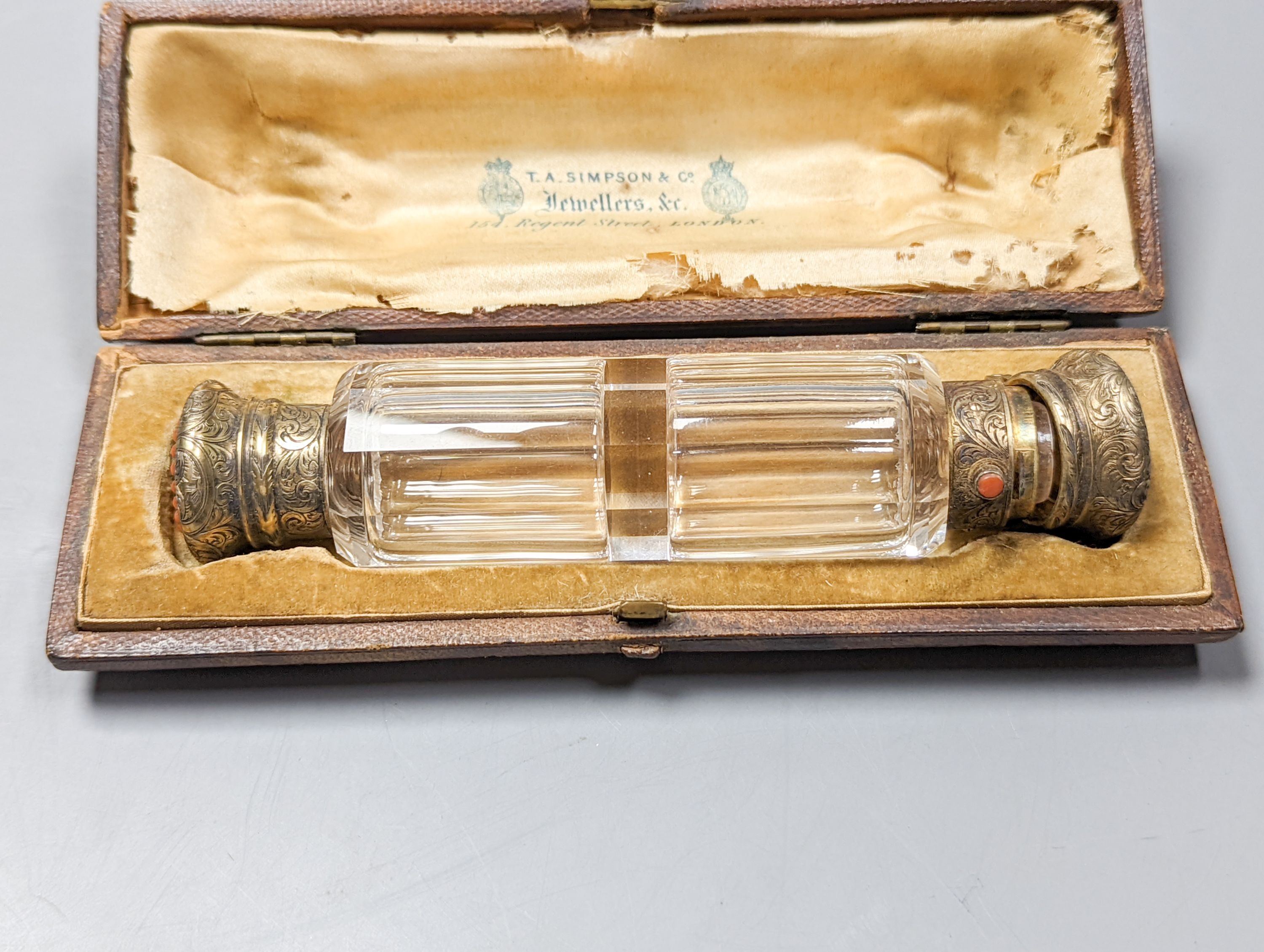A cased Victorian engraved gilt white metal and coral set double ended scent bottle, 13.4cm, a silver cigar cutter, a belt, a silver buckle, gilt and cranberry perfume bottle, etc.